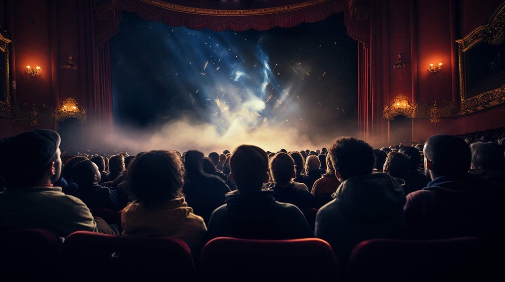 an audience in a theater watching a magical show