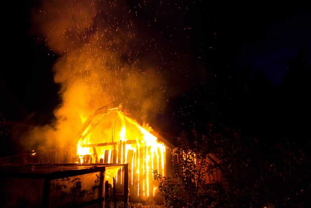 a barn on fire at night
